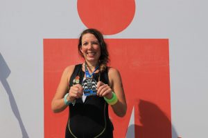 EduMais volunteer Anna Bowman showing her IronMan medal