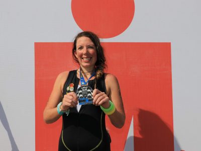 EduMais volunteer Anna Bowman showing her IronMan medal