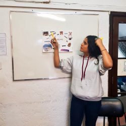 EduMais entrepreneurship program student in Rio de Janeiro's favelas presents her passions board