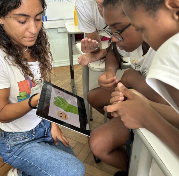 English Program Brain in hand model woman with iPad and kids watching video
