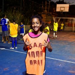 EduMais student Nicolle poses for the camera on the football pitch