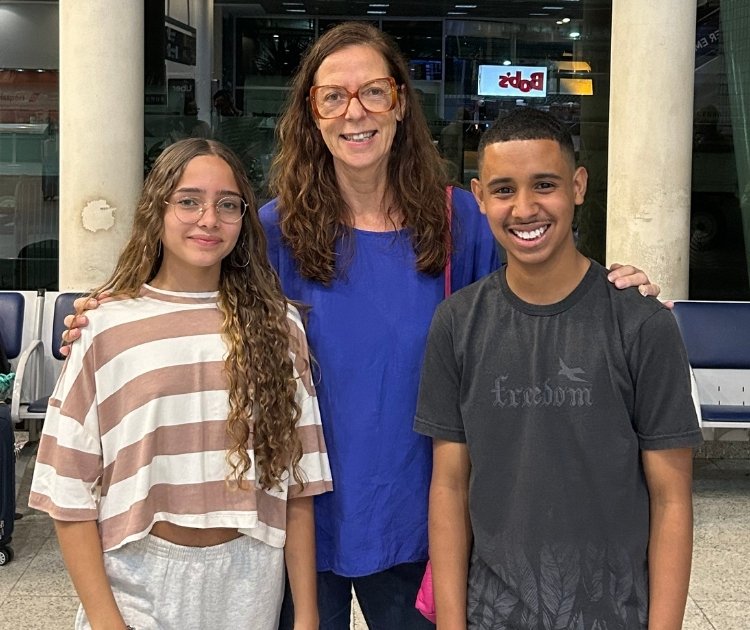 Two women and a young man at the waiting hall in the airport