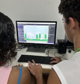Game Design Two kids programming a game in GDevelop in the EduMais Summer Camp in the favelas of Rio de Janeiro