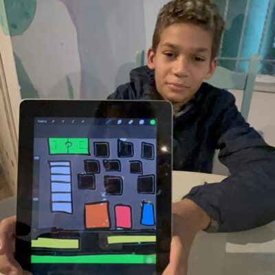 Boy with iPad and art work