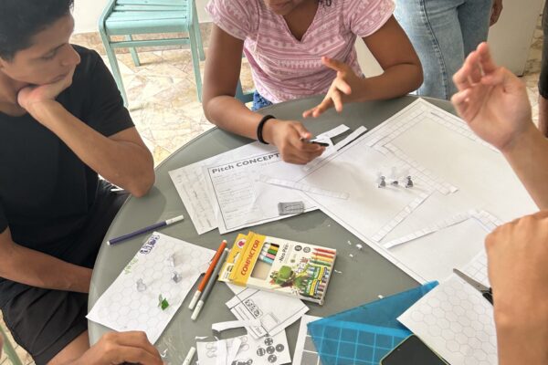Kids around the table making a board game