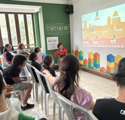 Screen with a game and people watching