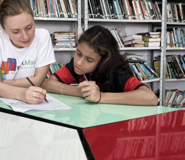 Student and teacher writing Student and teacher writing. Books in the background